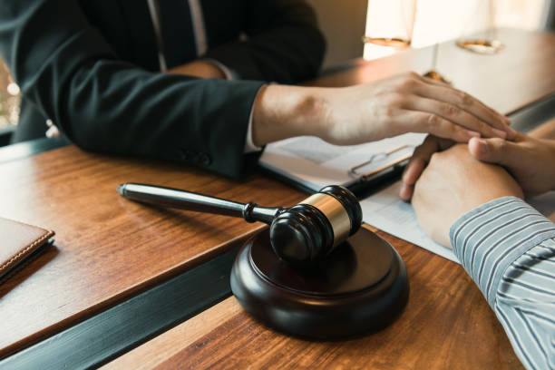 istock Lawyer and the court are using their hands to console the client who is aware that they will not win the case. 1249087014