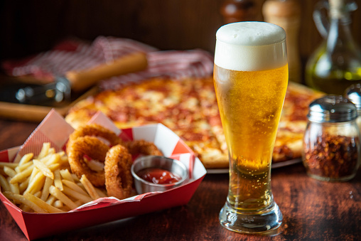 ice cold beer with pizza and french fries