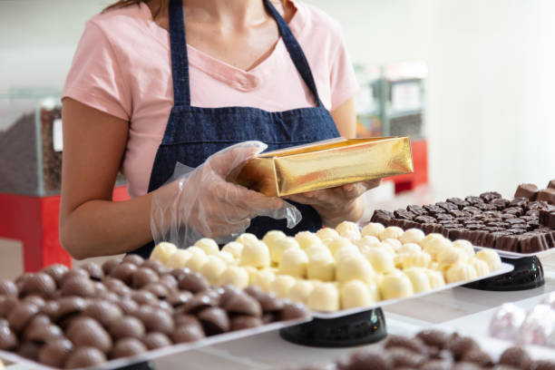 istock Employee packing chocolates at chocolate store 1249090658