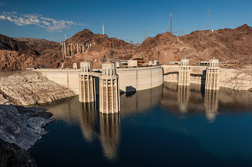 Hoover Dam, on the Colorado River, built 1931 to 1935, between Nevada and Arizona near Boulder City Nevada. Mojave Desert. Lake Mead impounded by the dam. A concrete arch-gravity dam in the Black Canyon of the Colorado River.