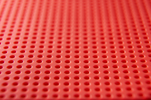 red color honeycomb structure with many holes