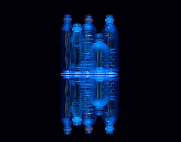 istock Neon blue illuminated clear recycle plastic water bottles. 1249095467