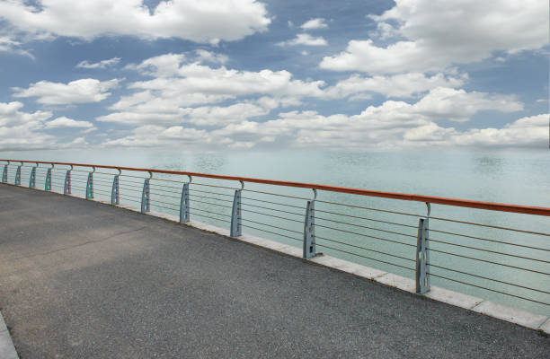 Asphalt with guardrail on the seashore under clear sky