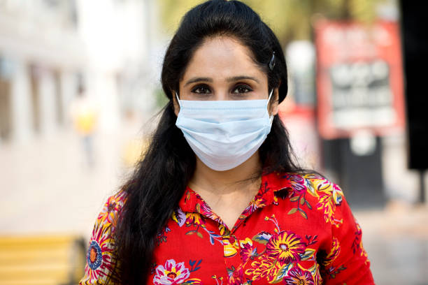 istock Woman with face mask in city post lockdown 1249099812