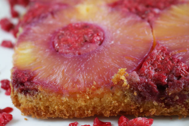 Image of photo of homemade raspberry and pineapple upside down cake freshly baked in square dish, ready to eat cake / pudding, baked in single pan with pineapple slice at the bottom of dish and turned upside down when served hence named upside down cake
