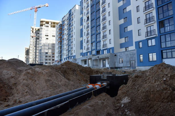 istock Laying heating pipes in a trench at construction site. Install underground storm systems of water main and sanitary sewer. 1249106840