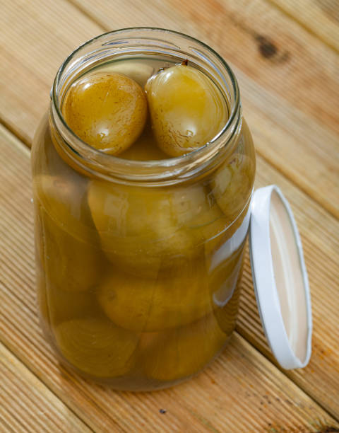 istock Glass jar with salted green tomatoes 1249111654