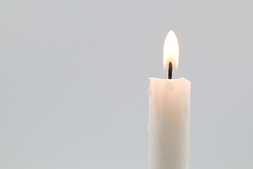 white candle flame right side on white background