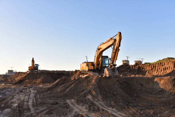 istock Excavators working at construction site on earthworks. Backhoe digging building foundation 1249114376