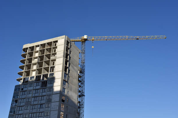 istock Tower crane working at construction site on blue sky background with white clouds 1249115827