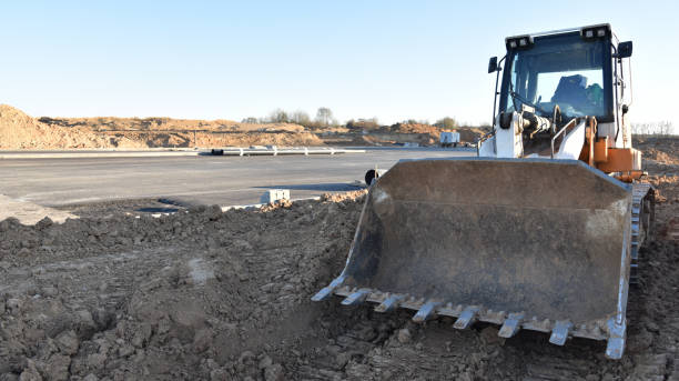 istock Crawler loader working on dirt at construction site. Earth-moving equipment for land clearing, grading, pool excavation, utility trenching and foundation digging 1249117836