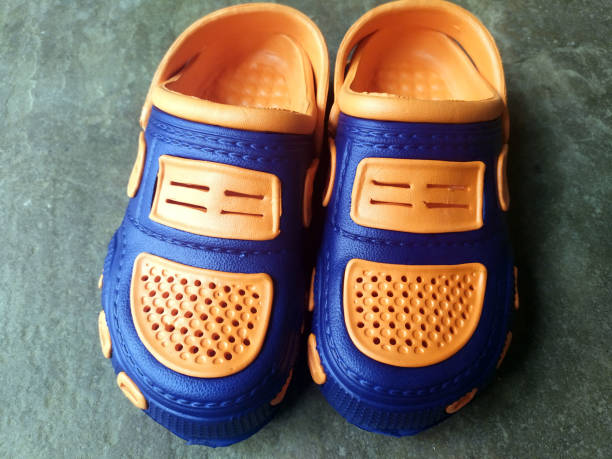 istock colorful child shoes isolated on stone background 1249118113