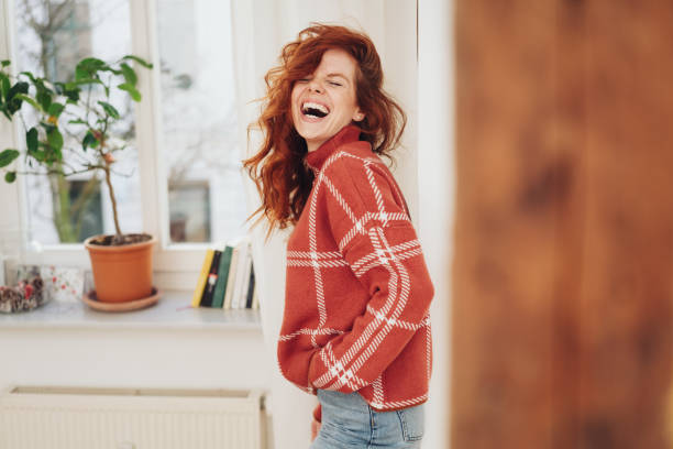 istock Exuberant young woman laughing out loud 1249118907
