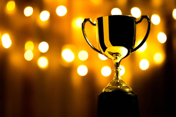 istock Gold trophy on the background bokeh lights for the award ceremony 1249121521
