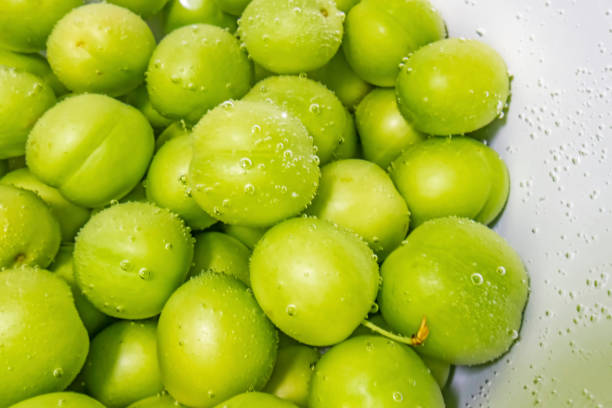 istock washed green plums in water 1249122891