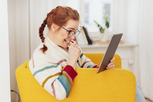 istock Excited young woman reading an e-book 1249123546