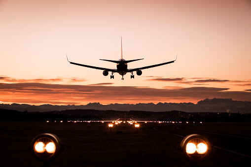Passenger airplane landing at dusk