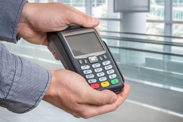 istock Payment terminal in hand of man 1249124588