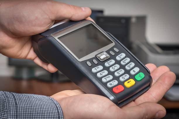 istock Payment terminal in hand of man 1249124602