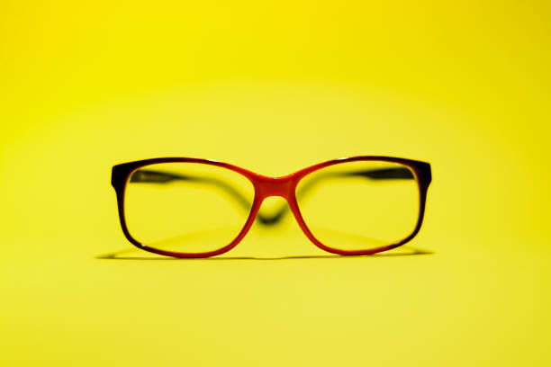 istock Red black glasses on the yellow background. 1249124629