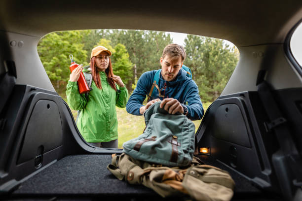 istock Diligent man packing his backpack from the car trunk before their adventure 1249126191