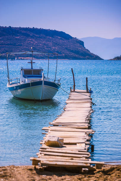 istock Jetty pier on coastline with boat yacht. 1249133140
