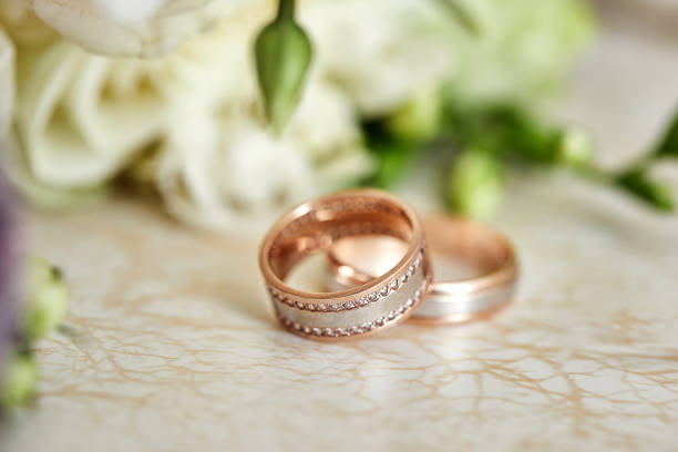 istock wedding rings lie near bridal bouquet 1249140406