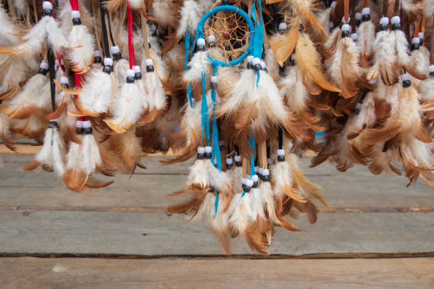 istock Dream catchers. Handmade on a wooden background. Multi-colored with white-redhead feathers. 1249141447