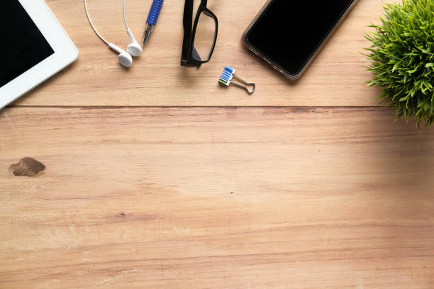 istock high angle view of smart phone and office suppliers on table with copy space 1249144386