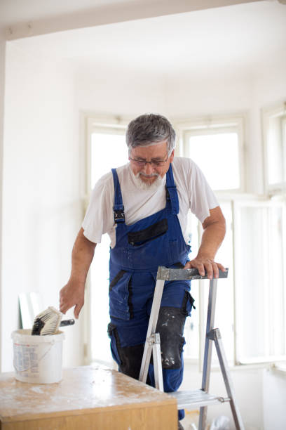 istock Senior man painting a room white 1249145635