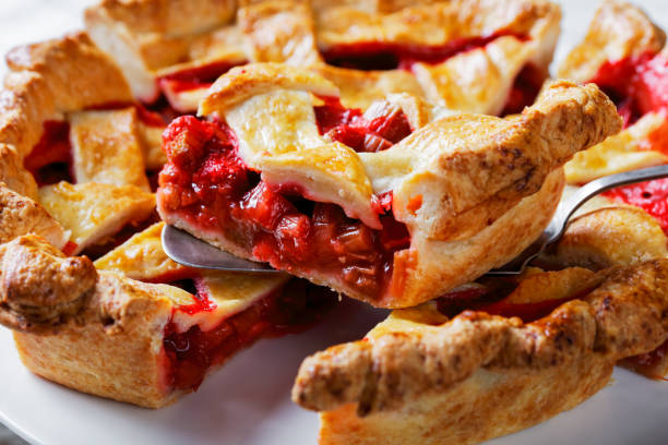 close-up of freshly baked Homemade Strawberry Rhubarb Pie slices on a white cake plate