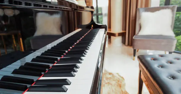 Photo of piano keyboard in music living room at modern luxury house, selective focus