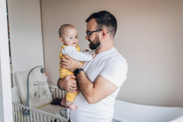 istock Father and baby son at home together 1249156956