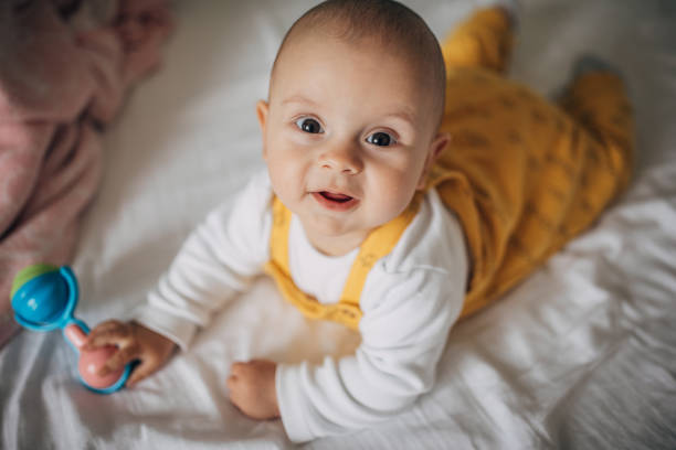 istock Beautiful baby boy lying on bed 1249158345
