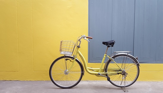 yellow bicycle with yellow wall and gray window.retro bicycle pastel color.

S