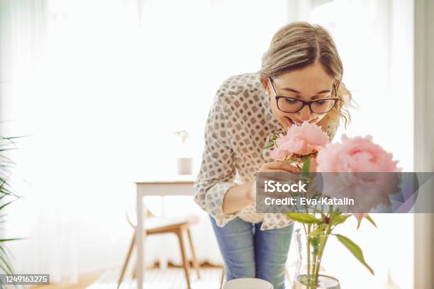 Young Woman At Home Stock Photo - Download Image Now - Flower, Women, One Woman Only