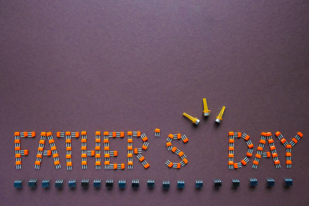 istock Congratulation on Father's Day composed of transistors and microcircuits on a brown background. Male holiday, father's day concept. copy space. 1249167507