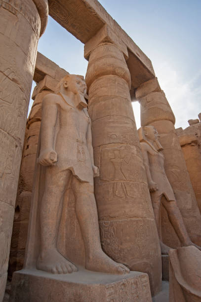 istock Statue and hieroglyphic carvings at an ancient egyptian temple 1249167790