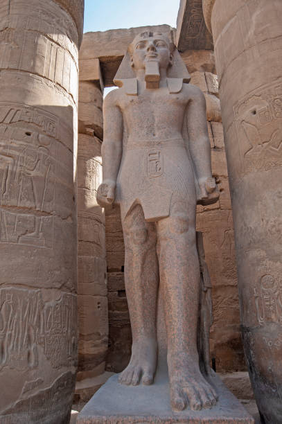 istock Statue and hieroglyphic carvings at an ancient egyptian temple 1249167817