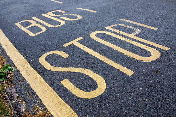 Bus stop sign on asphalt