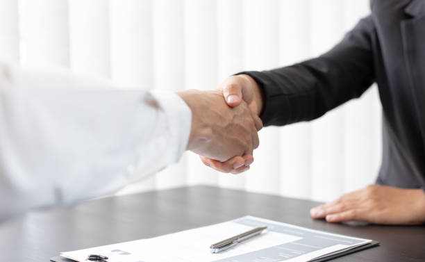 istock Midsection Of Manager Giving Handshake To Candidate In Office 1249169928