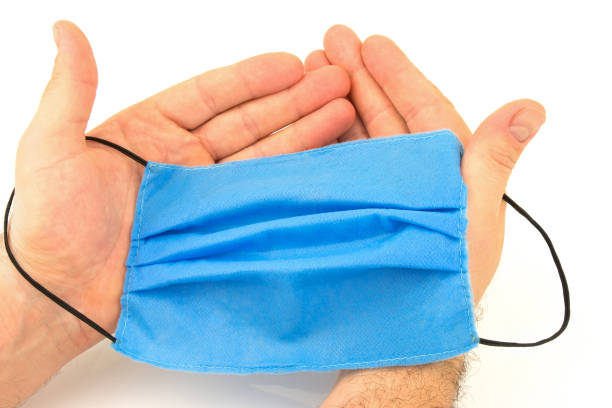 istock Male hands with medical mask 1249171223