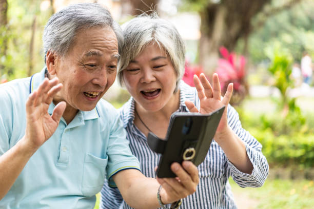 istock Senior couple having video call with family using smartphone 1249171320