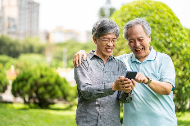 istock Taiwanese father and son using smartphone at public park 1249171476