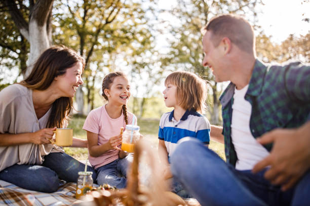 istock Happy family enjoying in talk on a picnic in spring day. 1249173749