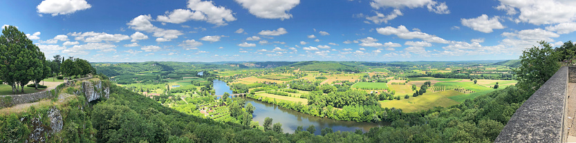 Panoramic sunny summer view of the Dordogne river from Domme, classified as one of the most beautiful villages of France, occupying a splendid position high above the Dordogne Valley