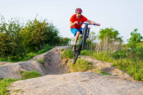 istock Professional cyclist in a bright T-shirt performs a jump. 1249174441