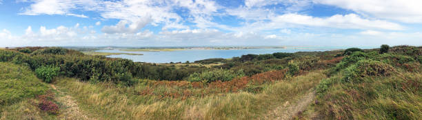 Panorama of Christchurch Harbour, Dorset, England Panoramic scenery view from Hengistbury Head, headland peninsula of the beautiful tranquil natural recreational harbour of Christchurch Harbour, leading to Christchurch seen in the distance hengistbury head photos stock pictures, royalty-free photos & images