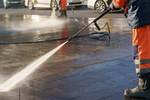 istock Worker watering from a hose outdoor. 1249174748