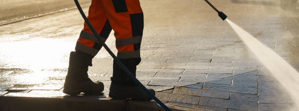 istock Worker watering from a hose outdoor. 1249174754